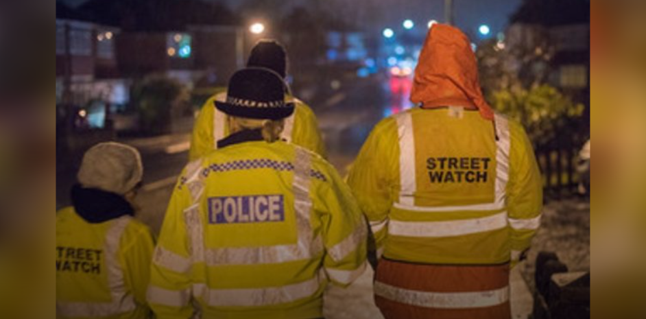 Trained Glasgow Streetwatch volunteers walking together on a city sidewalk